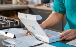 Person holding lancet and instructions